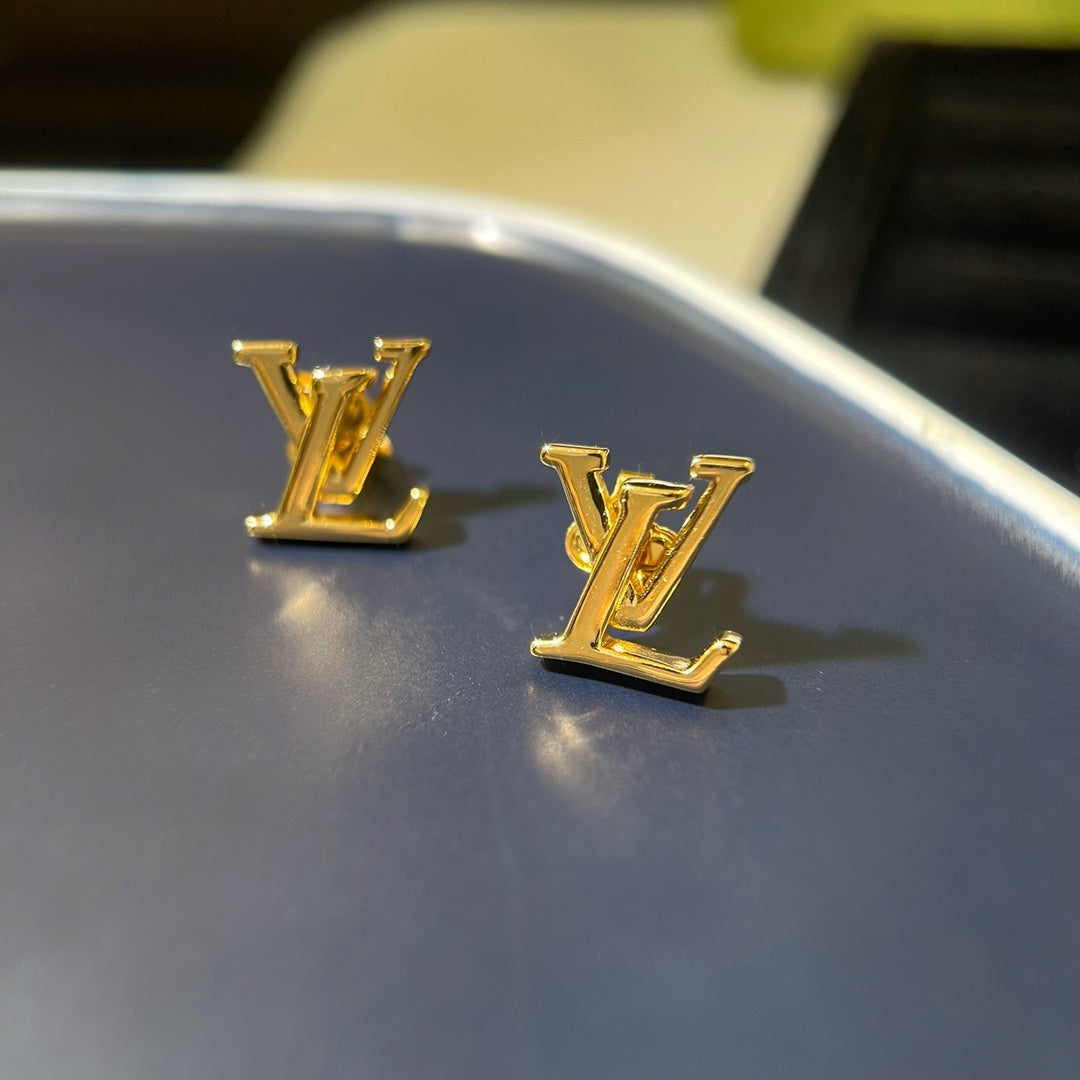 LV logo shops gold earrings